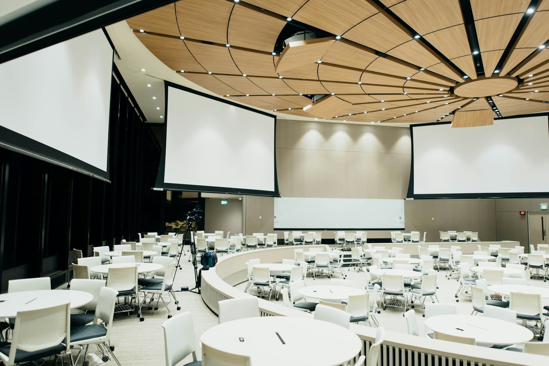 Conference hall with round tables prepared for a corporate event