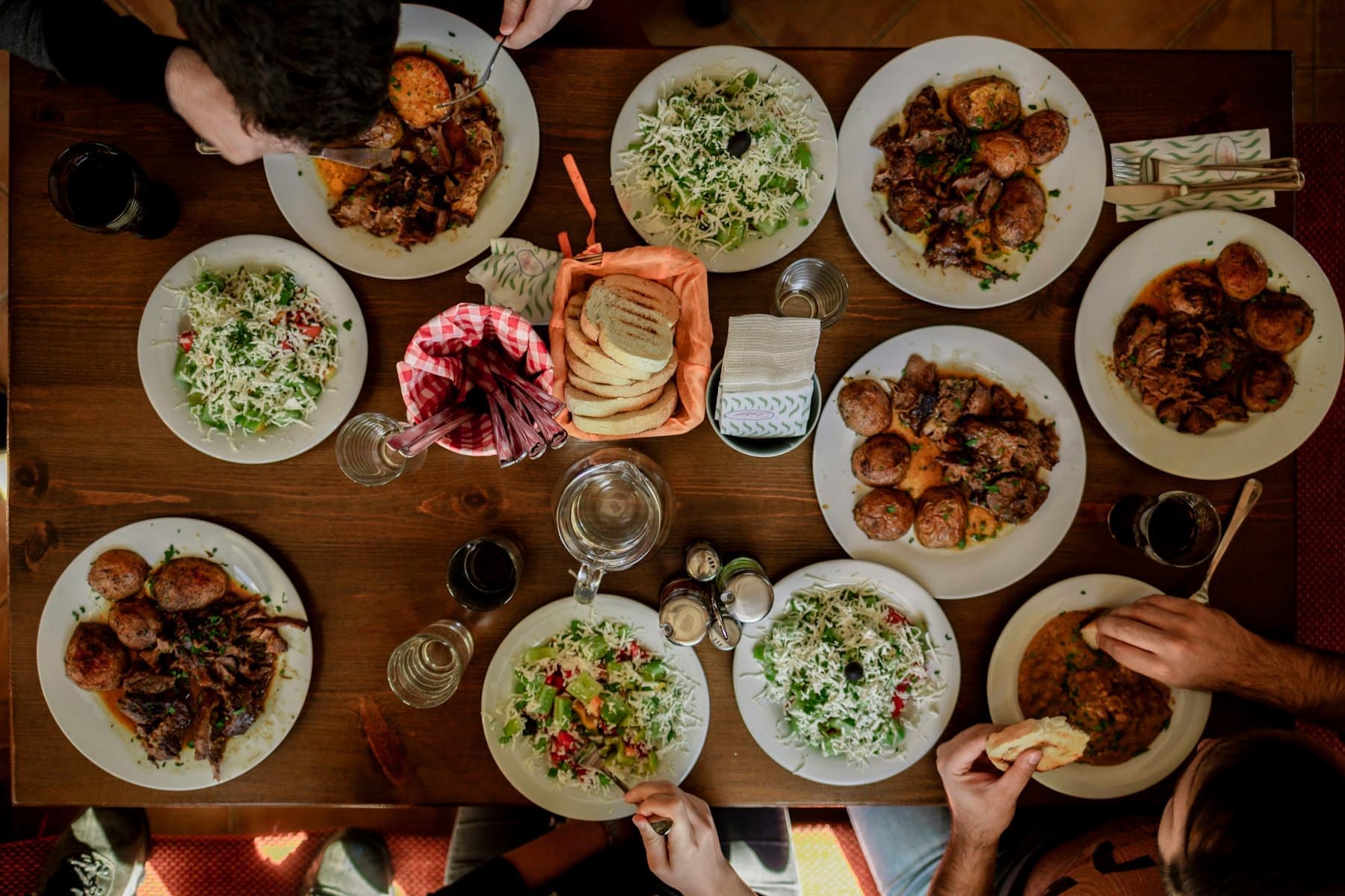 Family sharing a table covered with plates of food