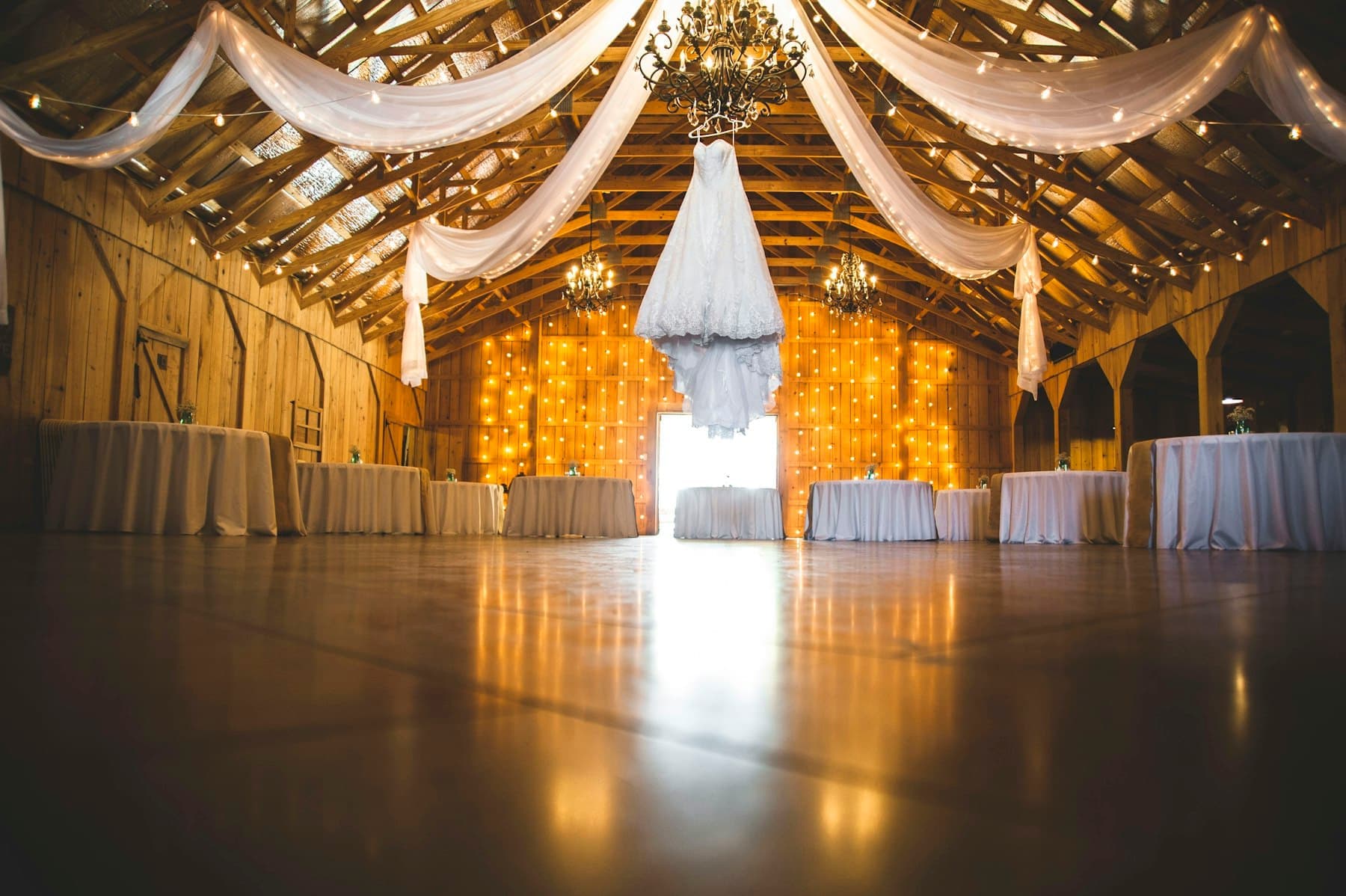 Banquet hall draped in fabric and warm lights for a special function