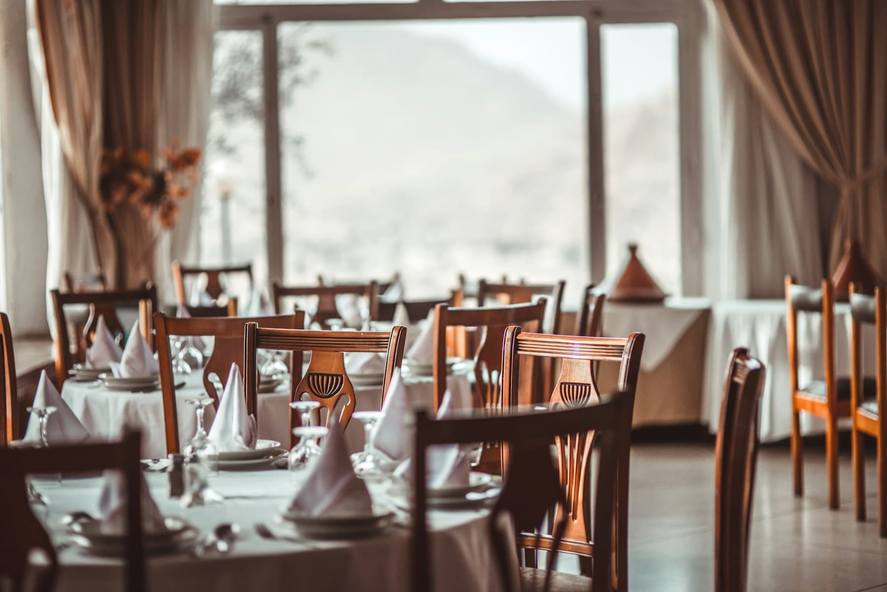 Dining room with tables laid and napkins folded for a function