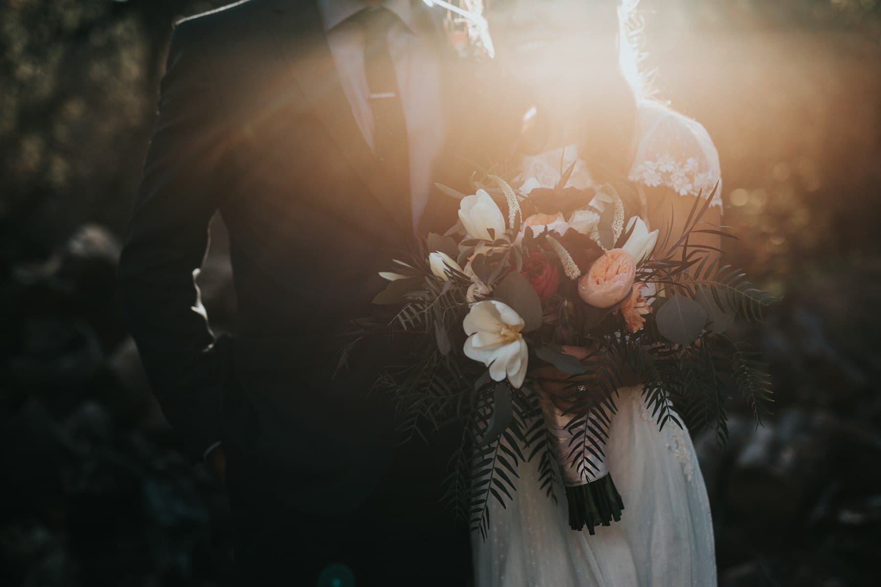 Bride holding a bouquet in soft evening light