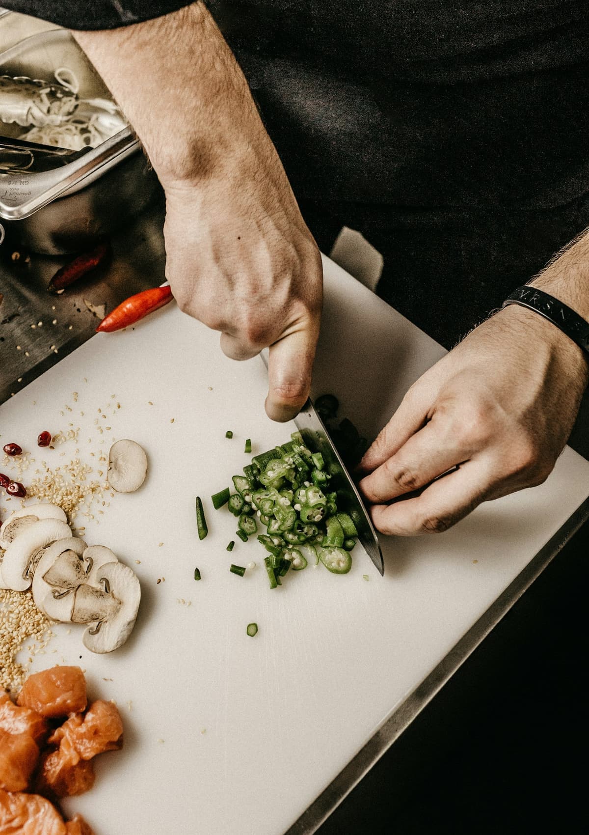 Hands chopping fresh vegetables during kitchen preparation